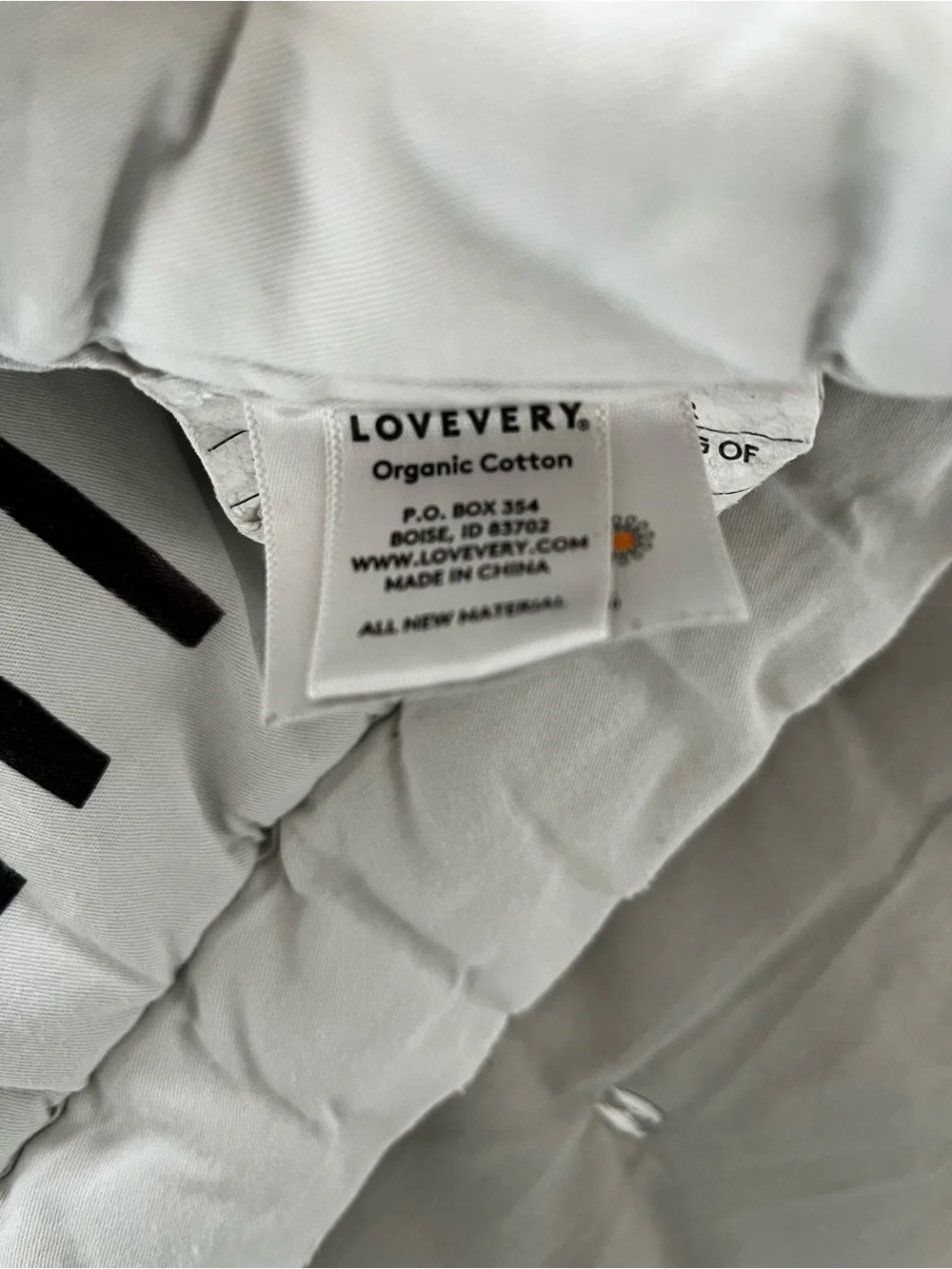Lovevery organic comforter with animals and stripes